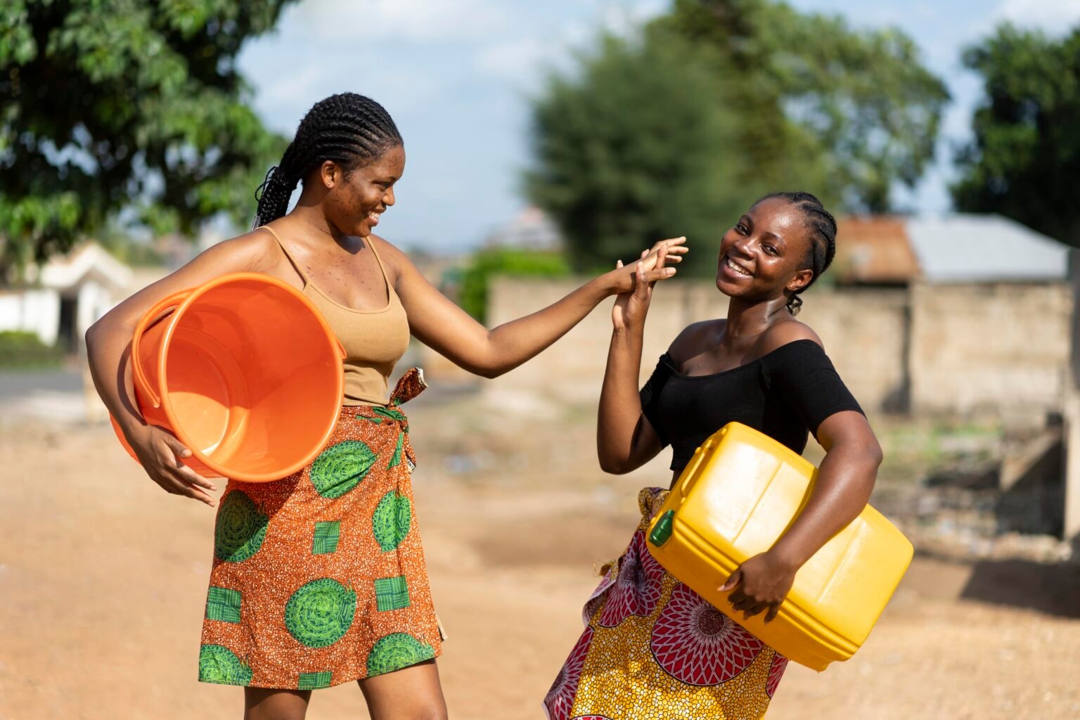 Tolinda Foundation community — women fetching water